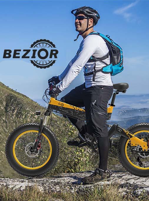 Bezior electric bike yellow side view outdoors with rider on a mountain trail