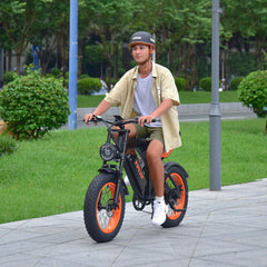 Person riding an VIPCOO VM6 Electric City Bike on a sidewalk with greenery in the background - Pogo Cycles, UK