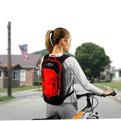 A girl wearing INOXTO 6L Cycling Bag Men's Women Riding Waterproof Breathable Bicycle Backpack with a bike in an urban area - Pogo Cycles