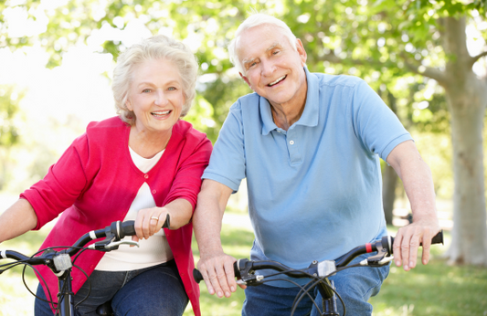 Senior couple cycling in the road