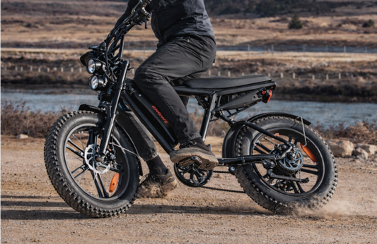 ENGWE M20 electric bike in black, side view, ridden on an outdoor dirt trail