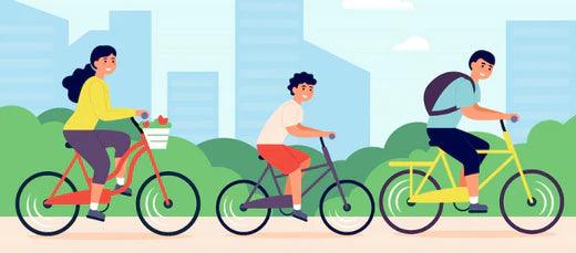 Three people riding bikes in a park with city buildings in the background, side view