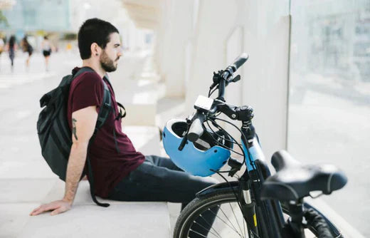 Electric bike with black frame and blue helmet side view, urban commuting setting