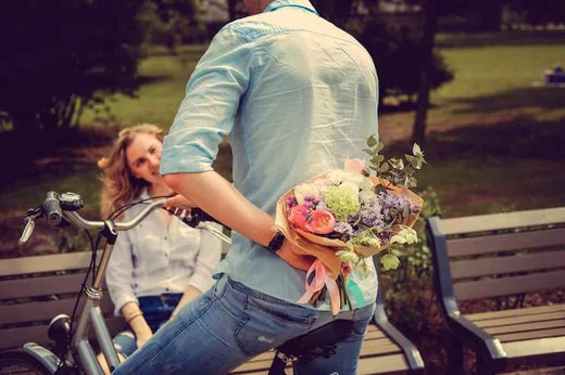 Electric bike in a park setting with a bouquet, person sitting on a bench nearby
