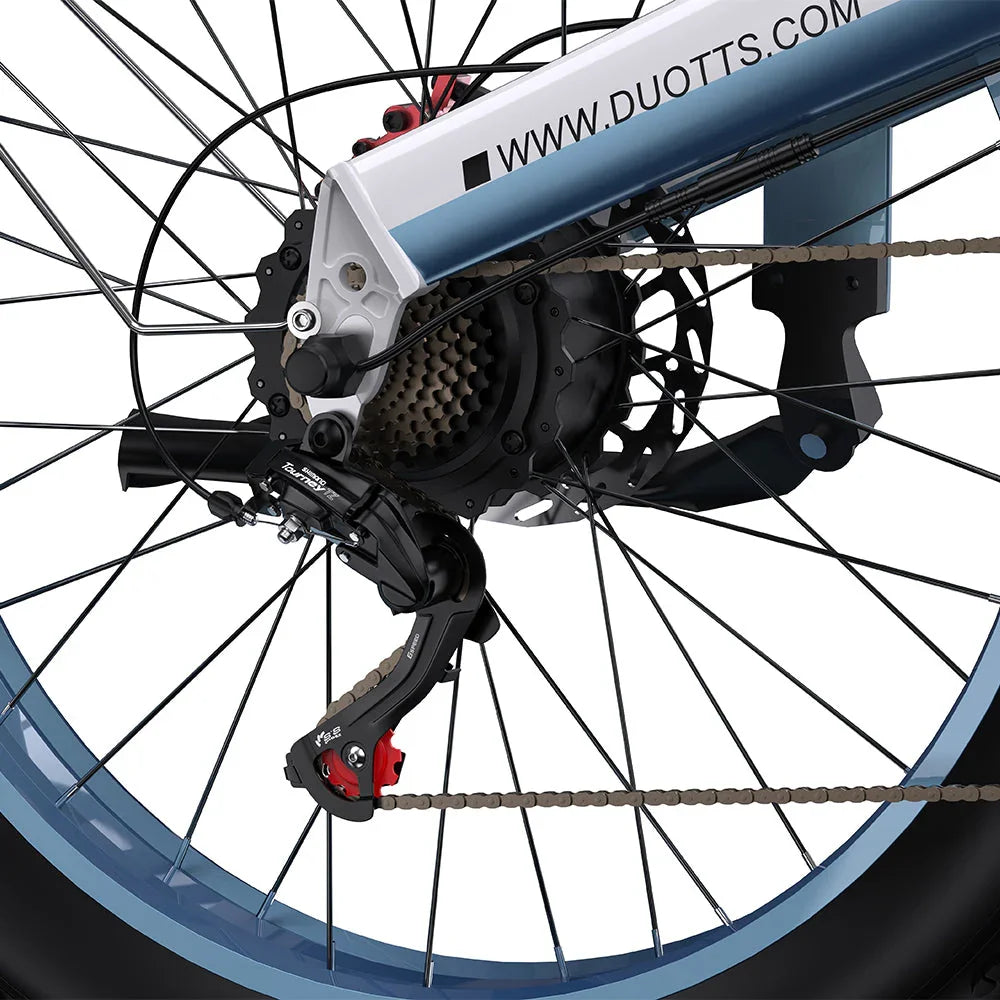 Close-up of a DUOTTS N26 Electric Bike wheel with gear and chain mechanism, featuring Duotts.com branding.