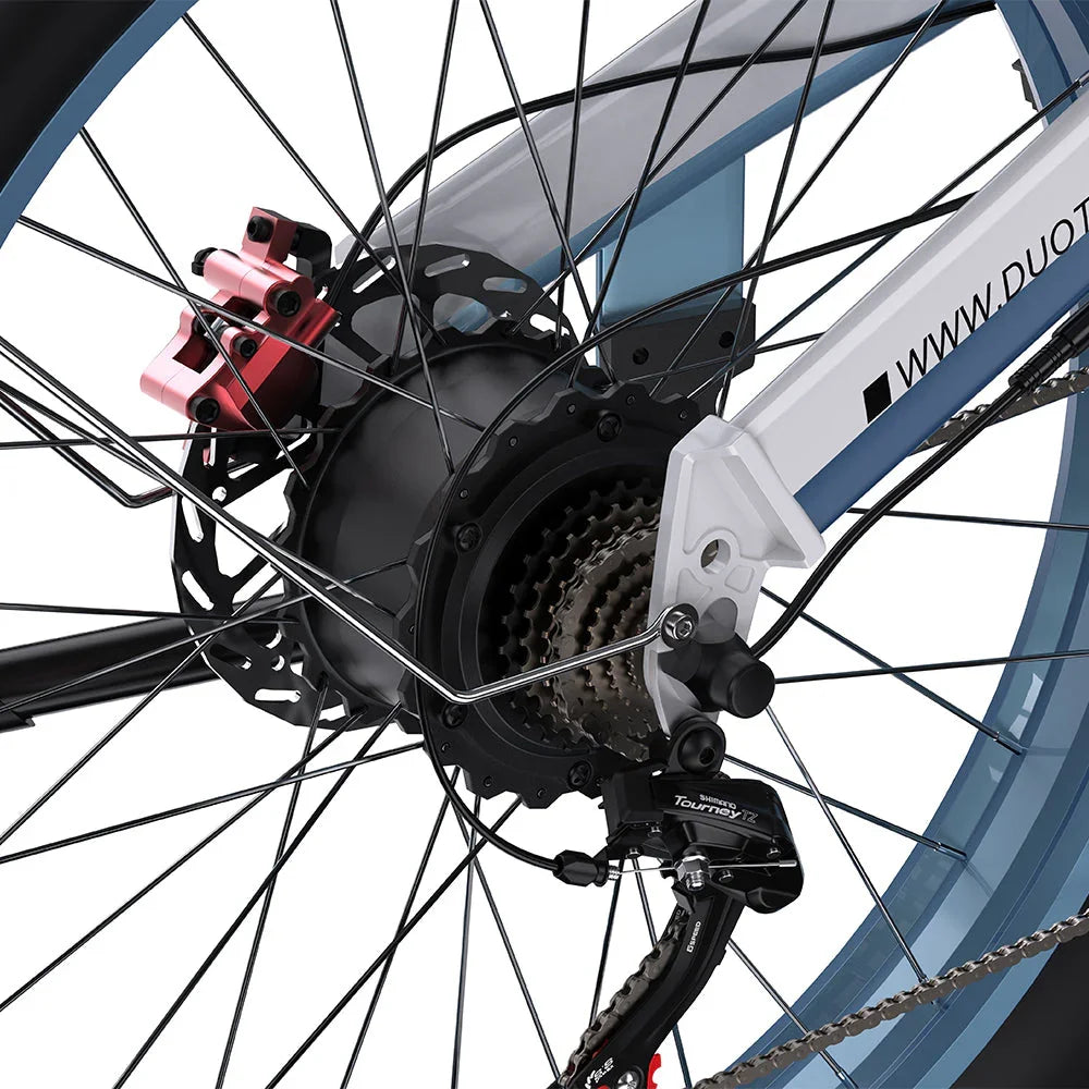 Close-up of a DUOTTS N26 Electric Bike wheel with gear and chain mechanism on a white background
