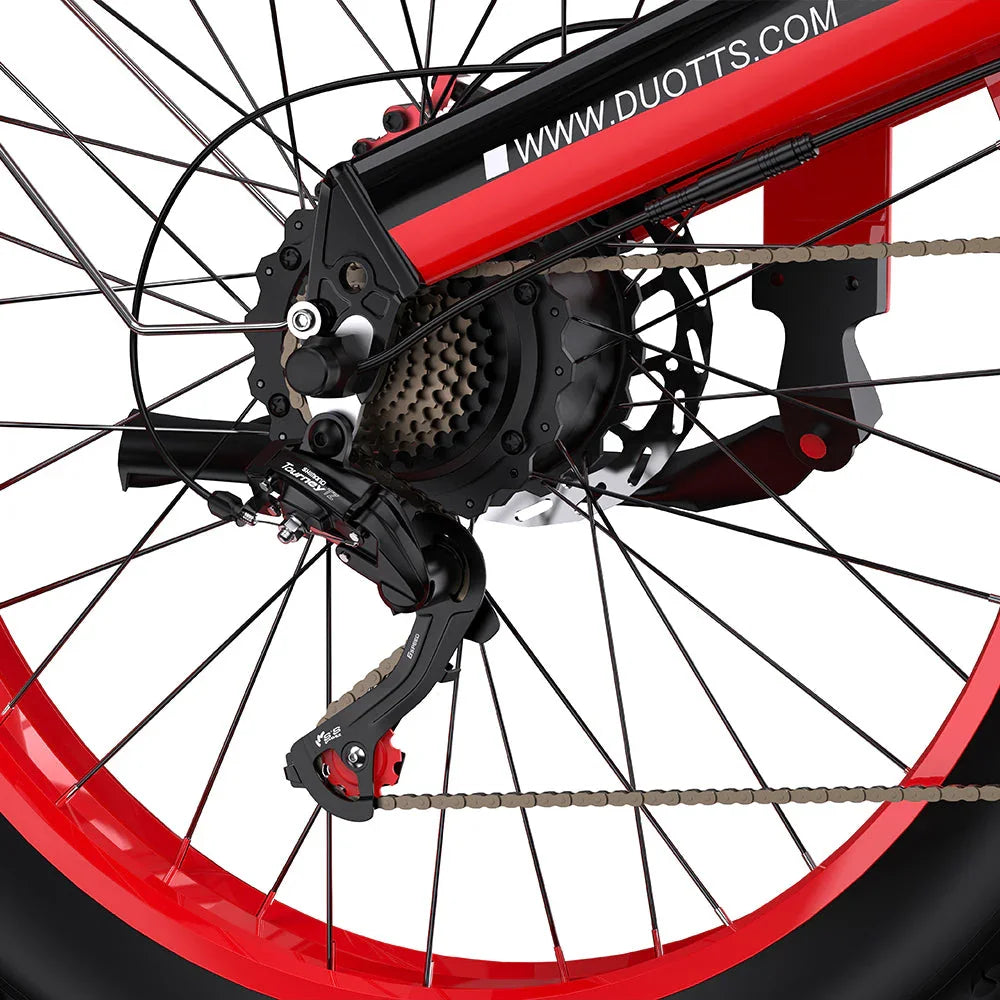 Close-up of a DUOTTS N26 Electric bicycle wheel with red rim and black components on a white background.