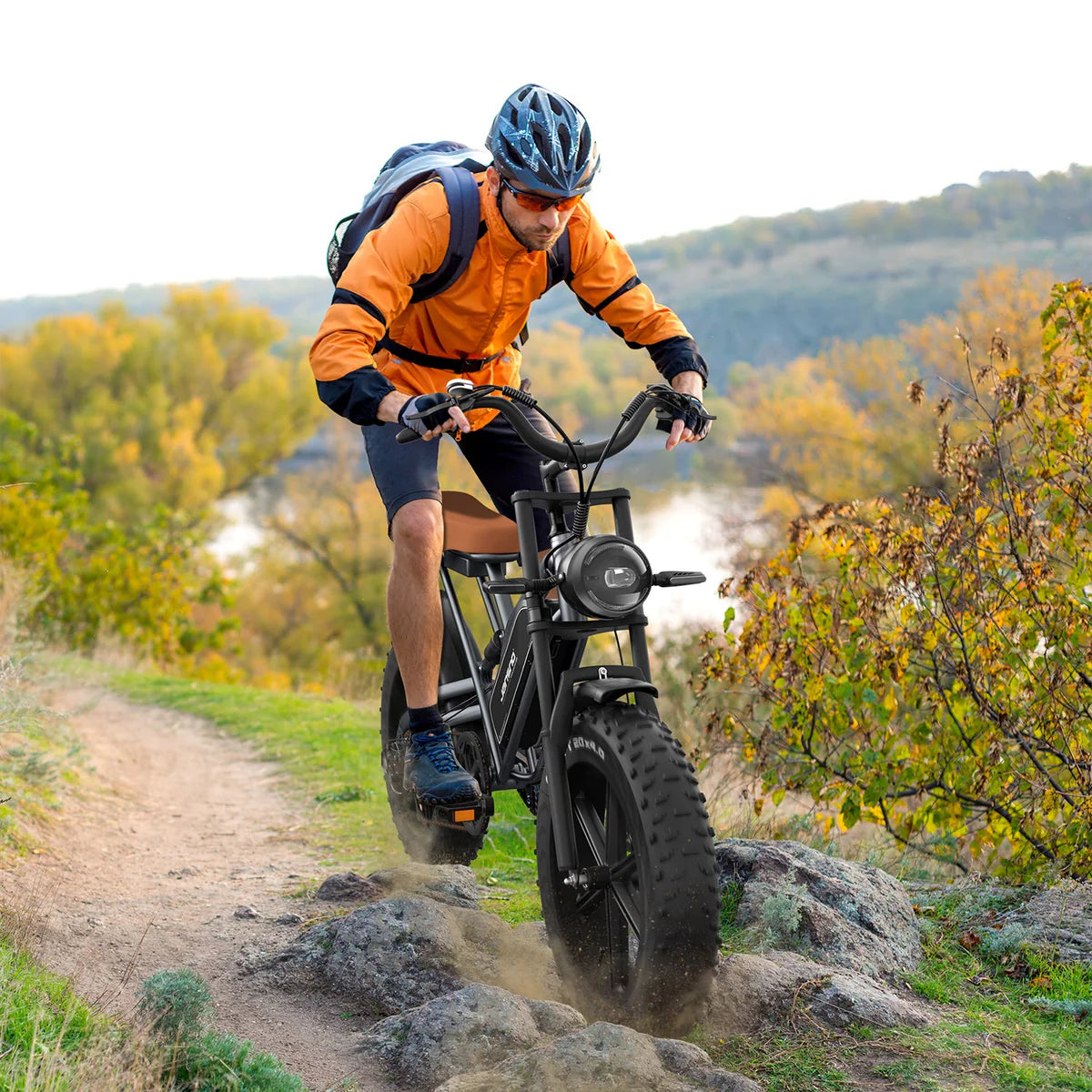 JANSNO X50 electric bike in black, side view, ridden off-road on a forest trail