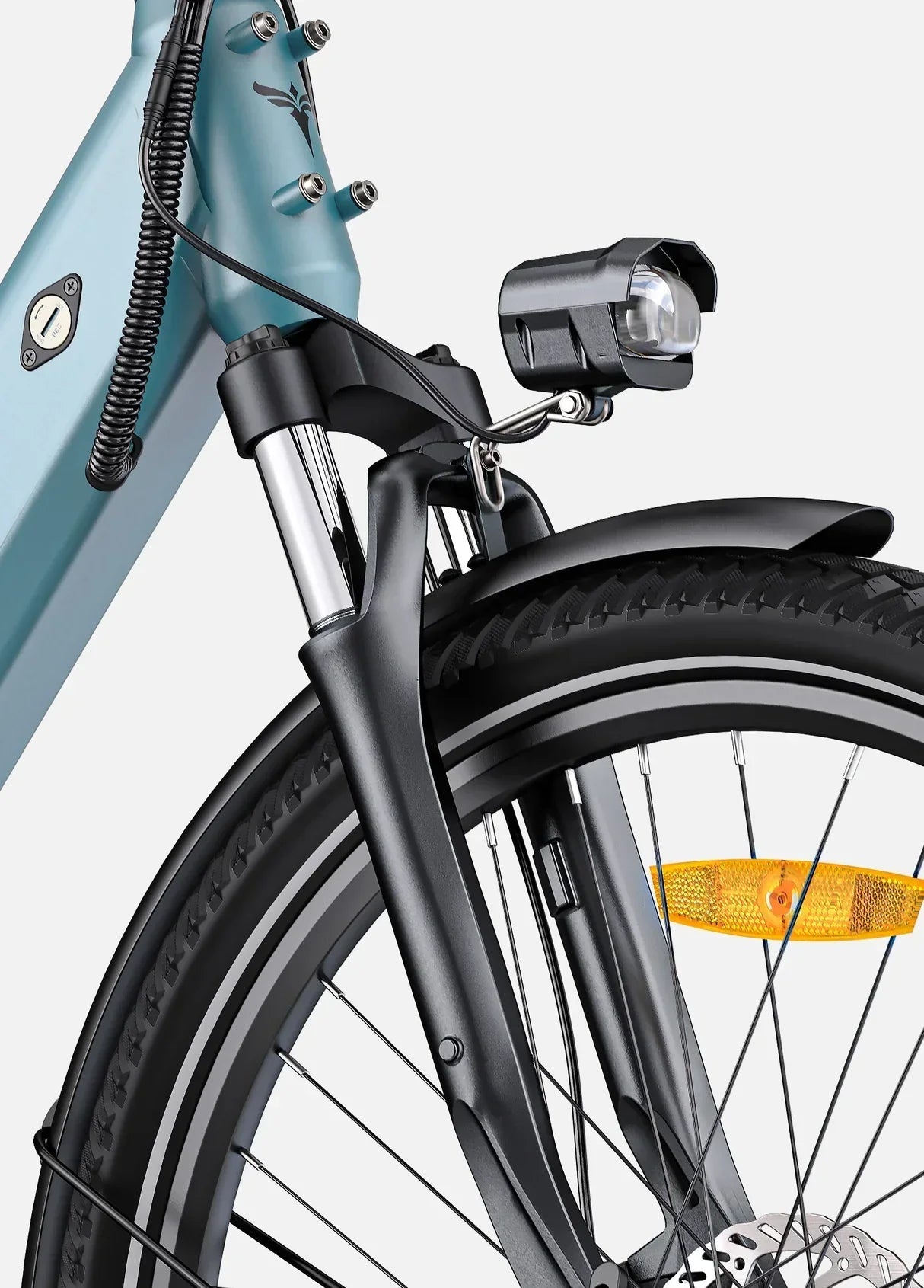 Close-up of a bicycle's front wheel and headlight on a light blue background