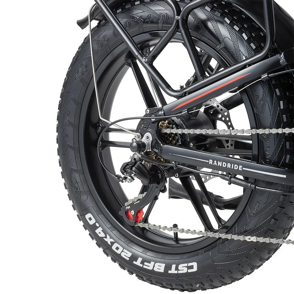 Close-up of a RANDRIDE YX20M-2 Dual Motor Electric motorcycle wheel with chain and 'Randride' branding on a white background