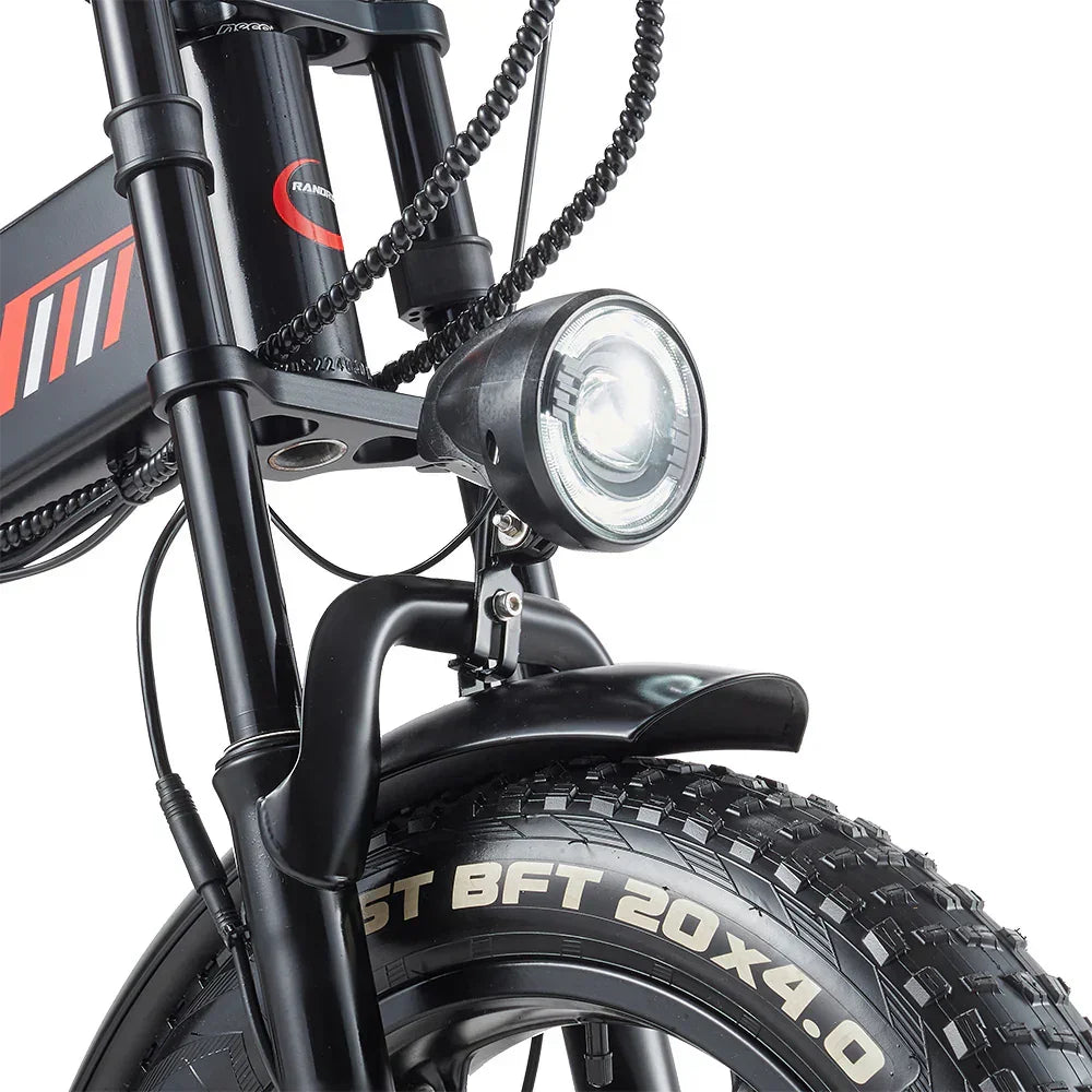 Close-up of a RANDRIDE YX20M-2 Dual Motor Electric bicycle headlight and front tire with visible branding on a white background